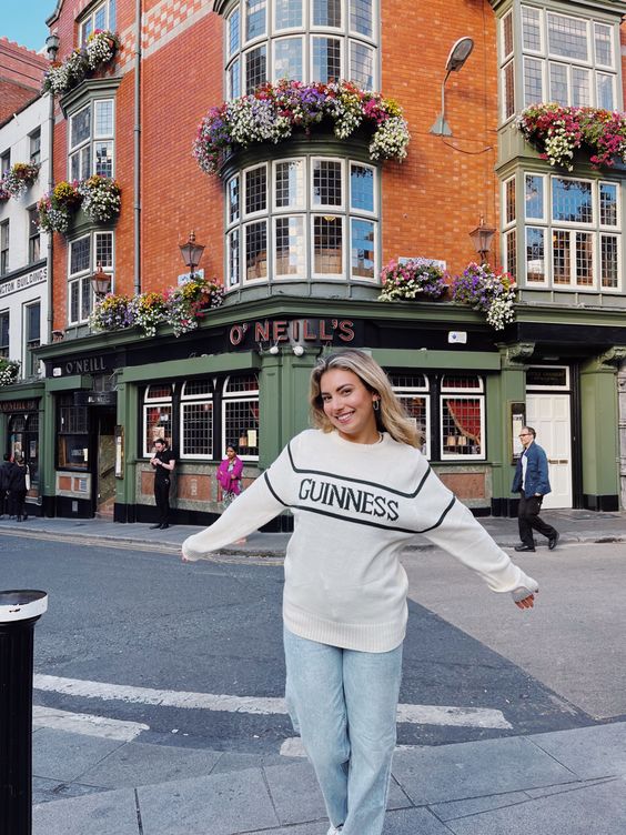 Custom Knitted Jumper black on white, Guinness logo, woman tourist in Ireland